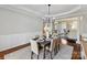 Elegant dining room featuring hardwood floors, wainscoting, and stylish chandelier at 18322 Indian Oaks Ln, Davidson, NC 28036