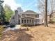 Exterior home view with backyard firepit, sunroom, pergola and deck at 18322 Indian Oaks Ln, Davidson, NC 28036