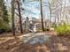 Exterior view of the home featuring back patio with fire pit and large treeline at 18322 Indian Oaks Ln, Davidson, NC 28036