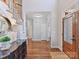 Bright foyer featuring hardwood floors, staircase, and front door with decorative glass at 18322 Indian Oaks Ln, Davidson, NC 28036