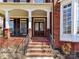 Brick front entrance with covered porch and double doors with glass inserts at 18322 Indian Oaks Ln, Davidson, NC 28036
