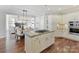 Well-lit kitchen featuring a center island, stainless steel appliances, and cabinetry that overlooks the dining room at 18322 Indian Oaks Ln, Davidson, NC 28036