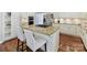 Well-equipped kitchen featuring an island with barstool seating, stainless steel appliances, and hardwood floors at 18322 Indian Oaks Ln, Davidson, NC 28036