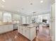 Open-concept kitchen with an island, granite countertops, stainless steel appliances, and hardwood floors at 18322 Indian Oaks Ln, Davidson, NC 28036