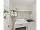 Functional laundry room with a side-by-side washer and dryer and plenty of storage space on the shelves at 18322 Indian Oaks Ln, Davidson, NC 28036