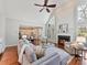 Open-concept living room with a fireplace, and hardwood floors that connects to the kitchen and dining area at 18322 Indian Oaks Ln, Davidson, NC 28036