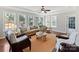Bright, neutral living room features lots of natural light, a decorative ceiling fan, and two chairs at 18322 Indian Oaks Ln, Davidson, NC 28036