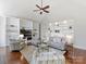 Bright living room features a high ceiling, built-in shelving, hardwood floors, and comfortable seating at 18322 Indian Oaks Ln, Davidson, NC 28036