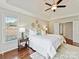 Spacious main bedroom features a tray ceiling, neutral paint, hardwood floors, and multiple windows at 18322 Indian Oaks Ln, Davidson, NC 28036