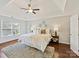 Spacious main bedroom features a tray ceiling, neutral paint, hardwood floors, and multiple windows at 18322 Indian Oaks Ln, Davidson, NC 28036