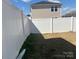 Enclosed backyard with a pristine white fence offering privacy and a neat lawn at 202 J.P. Dr # 183, Albemarle, NC 28001