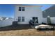 Rear view of home with a white fence, a sliding glass door, and a modest backyard space at 202 J.P. Dr # 183, Albemarle, NC 28001