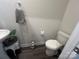 Stylish half bathroom with pedestal sink, toilet, modern fixtures, and elegant dark wood flooring at 202 J.P. Dr # 183, Albemarle, NC 28001