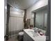 This well-lit bathroom offers a shower-tub combination, neutral color palette and a large mirror above the sink at 202 J.P. Dr # 183, Albemarle, NC 28001