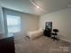 A serene bedroom with a single bed, complemented by a dark dresser and a bright window at 202 J.P. Dr # 183, Albemarle, NC 28001