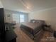 Neutral bedroom featuring a queen bed, contemporary furnishings, and natural light from the window at 202 J.P. Dr # 183, Albemarle, NC 28001