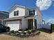 Charming two-story home with white siding, black shutters, and a brick-accented front exterior and a well-manicured lawn at 202 J.P. Dr # 183, Albemarle, NC 28001