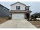 Well-maintained home featuring white siding, black shutters, a two-car garage, and a concrete driveway with landscaping at 202 J.P. Dr # 183, Albemarle, NC 28001