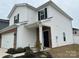 Close up of the exterior of a home featuring white siding, black shutters, and a brick-accented entrance at 202 J.P. Dr # 183, Albemarle, NC 28001