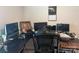 Home office setup with desk, multiple monitors, artwork, and office chair, providing a functional workspace at 202 J.P. Dr # 183, Albemarle, NC 28001