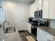 Modern kitchen featuring white cabinets, stainless steel appliances, granite counters, and a undermount sink at 202 J.P. Dr # 183, Albemarle, NC 28001