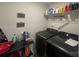 Functional laundry area equipped with modern washer and dryer, storage shelves, and utility supplies at 202 J.P. Dr # 183, Albemarle, NC 28001