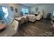 Open-concept living room with dining area, hardwood floors, comfortable seating, and ample natural light at 202 J.P. Dr # 183, Albemarle, NC 28001