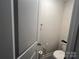 Simple powder room with a toilet and wall-mounted accessories offering basic functionality in a compact space at 202 J.P. Dr # 183, Albemarle, NC 28001