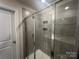 Enclosed glass shower featuring sleek tile work and a built-in shampoo niche, combining style and functionality at 202 J.P. Dr # 183, Albemarle, NC 28001