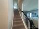 Carpeted staircase leads to the upper level, offering a transition to the home's living spaces at 202 J.P. Dr # 183, Albemarle, NC 28001