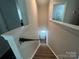 Carpeted staircase with a white handrail offers a safe and aesthetic transition to the second floor at 202 J.P. Dr # 183, Albemarle, NC 28001