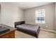 Bedroom featuring neutral walls and flooring, with a single window for natural light at 2026 Talbert Ct, Charlotte, NC 28214