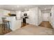 Bright kitchen featuring white cabinets, granite counters, and black appliances at 2026 Talbert Ct, Charlotte, NC 28214