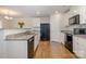 Modern kitchen featuring granite countertops, black appliances, and wood flooring at 2026 Talbert Ct, Charlotte, NC 28214
