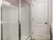 Shower with bright white tile, glass door, and chrome hardware at 2026 Talbert Ct, Charlotte, NC 28214