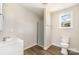 Bathroom with tiled shower and vanity sink with white cabinets at 2206 Hillcrest Ave, Albemarle, NC 28001