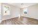 Bright bedroom with two windows and wood-look floors at 2206 Hillcrest Ave, Albemarle, NC 28001