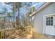 Wooden deck with railing and entry door with beautiful view of surrounding mature trees at 2206 Hillcrest Ave, Albemarle, NC 28001