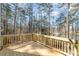 Large wooden deck overlooking wooded backyard with mature trees offers great outdoor living space at 2206 Hillcrest Ave, Albemarle, NC 28001