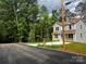 Charming two-story home with modern siding, complemented by a lush green lawn and surrounding trees at 2206 Hillcrest Ave, Albemarle, NC 28001