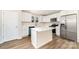 Bright kitchen features white cabinetry, stainless steel appliances, and a center island at 2206 Hillcrest Ave, Albemarle, NC 28001