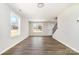 Bright living room with large windows, hardwood floors, and neutral paint at 2206 Hillcrest Ave, Albemarle, NC 28001