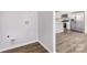 The room has wood-look floors and access to an adjacent kitchen at 2206 Hillcrest Ave, Albemarle, NC 28001