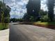 Newly paved street featuring a traditional mailbox, lined with mature trees and neighborhood homes at 2206 Hillcrest Ave, Albemarle, NC 28001