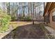 Exterior backyard shot featuring a screened in porch, mature trees, and surrounding nature at 2652 Gabriel Ct, Fort Mill, SC 29715