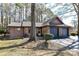 Charming single-story home with a brick facade and a two-car garage nestled amongst mature trees at 2652 Gabriel Ct, Fort Mill, SC 29715