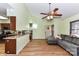 Open-concept living room with a view of the kitchen, wood floors, and a cozy gray sofa at 2652 Gabriel Ct, Fort Mill, SC 29715