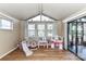 Bright sunroom with large windows, wood floors, and access to a screened-in porch at 2652 Gabriel Ct, Fort Mill, SC 29715