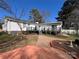 Back of house featuring a black deck, patio, and a well-maintained yard at 3240 Sunset Dr, Charlotte, NC 28209