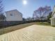 New wooden deck in a fenced backyard with a lovely tree offering shade and tranquility at 3400 Southern Ginger Dr, Indian Trail, NC 28079